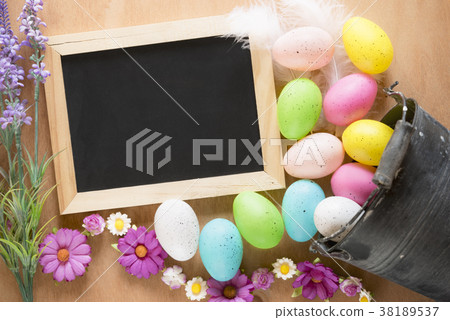 Bucket with Easter eggs and a chalkboard Bucket with Easter eggs and a chalkboard 38189537