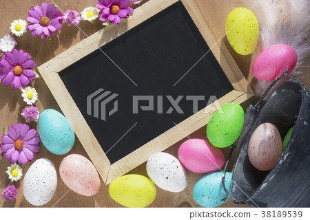 Easter eggs and a chalkboard with flowers 38189539