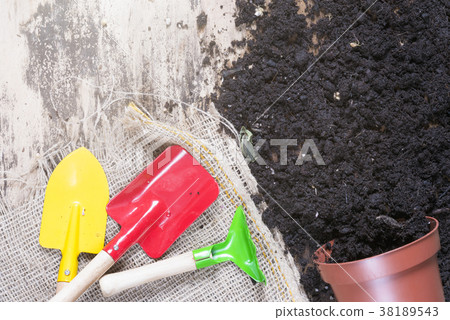 Overturned flower pot and gardening tools Overturned flower pot and gardening tools 38189543