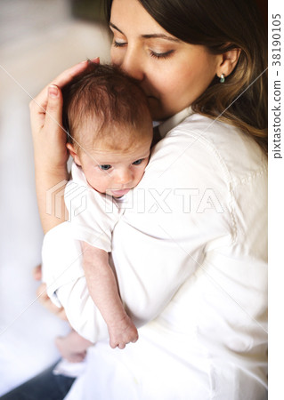 Young mother holding her newborn child Young mother holding her newborn child 38190105