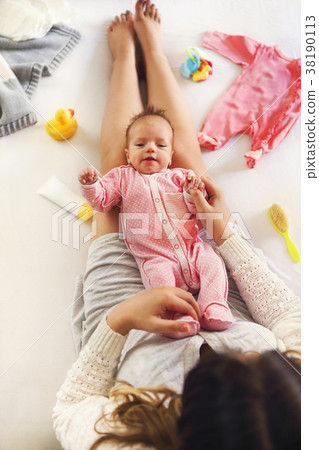 Young mother holding her newborn child Young mother holding her newborn child 38190113