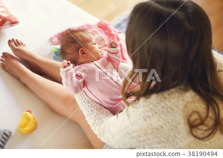 Young mother holding her newborn child. 38190494