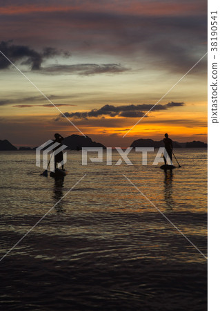 two man silhouette standing on sup boards on 38190541