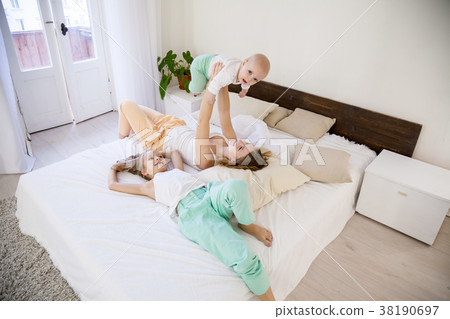 three girls sisters in the morning in the bedroom 38190697