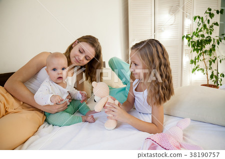 three girls play in the morning in the bedroom three girls play in the morning in the bedroom 38190757