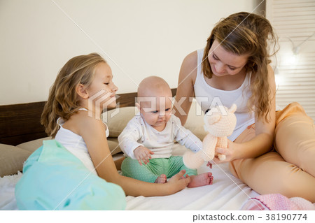 three girls play in the morning in the bedroom three girls play in the morning in the bedroom 38190774