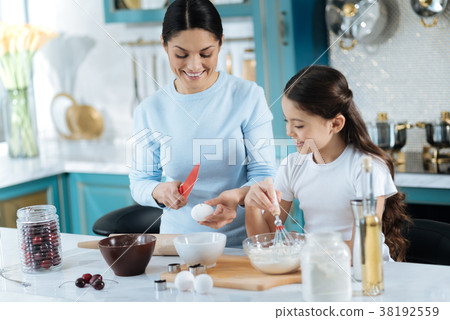 Happy mother and girl making some cookies 38192559
