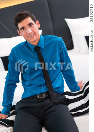 Man arriving in hotel room Man arriving in hotel room 38192719