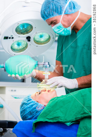 Doctor surgeon with patient in operating room 38192868