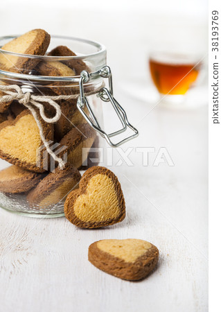 Heart-shaped cookies in a glass jar and red roses 38193769