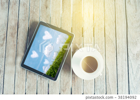 Black tablet ipad on table desk with coffee cup Black tablet ipad on table desk with coffee cup 38194092