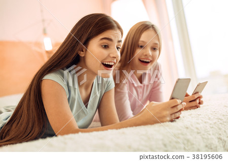 Upbeat friends looking through social networks and Upbeat friends looking through social networks and 38195606