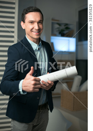 Optimistic male architect approving blueprint Optimistic male architect approving blueprint 38195829
