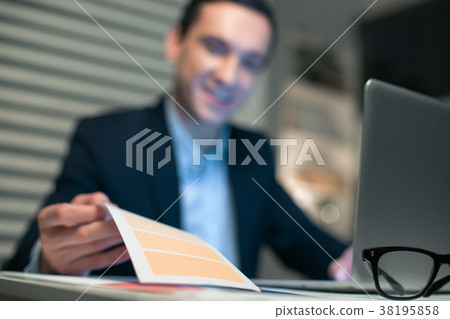 Young pleasant businessman taking notepaper Young pleasant businessman taking notepaper 38195858
