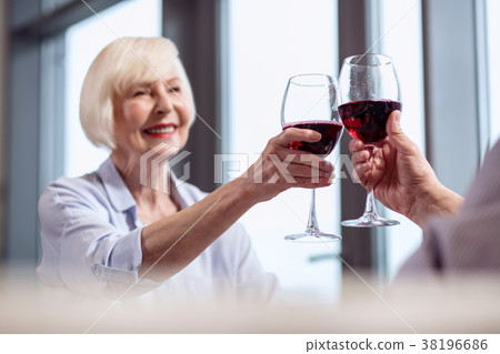 Satisfied mature woman dinging glasses Satisfied mature woman dinging glasses 38196686