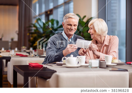 Optimistic mature couple receiving card Optimistic mature couple receiving card 38196828