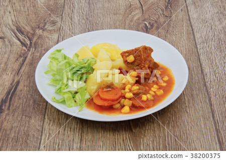 Mexican goulash with potatoes on a table Mexican goulash with potatoes on a table 38200375