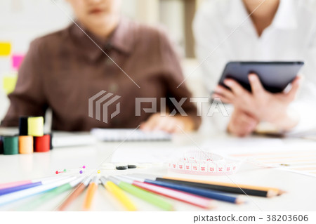 two young men working as fashion designers and drawing sketches two young men working as fashion designers and drawing sketches 38203606