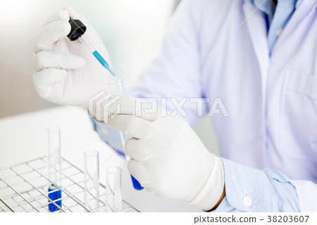 Scientist dropping adds the reagent from the dropper to test t Scientist dropping adds the reagent from the dropper to test t 38203607