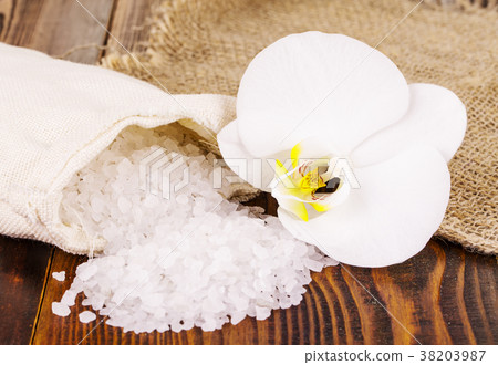 white bath salt and a bag with Orhid on wooden white bath salt and a bag with Orhid on wooden 38203987