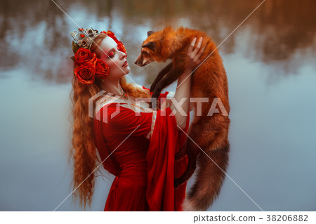 Woman in medieval clothes with a fox Woman in medieval clothes with a fox 38206882