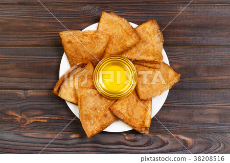 Homemade pancakes with honey on white plate 38208516