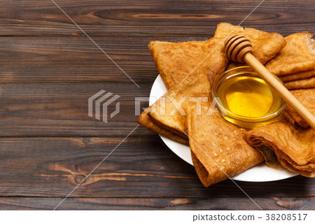 A pile of pancakes, honey, for the celebration 38208517