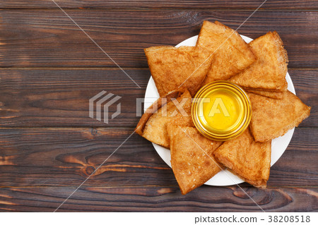 Pancakes with honey and butter on a wooden 38208518