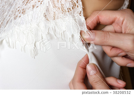 Bridal Gown Fitting. seamstress prepares dress Bridal Gown Fitting. seamstress prepares dress 38208532