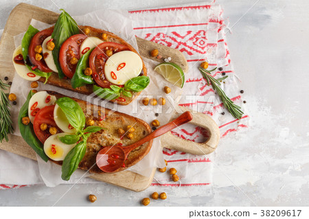 Caprese sandwich with mozzarella, tomato 38209617