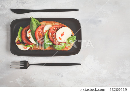 Caprese sandwich with mozzarella, tomato and basil Caprese sandwich with mozzarella, tomato and basil 38209619