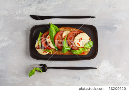 Caprese sandwich with mozzarella, tomato and basil 38209620