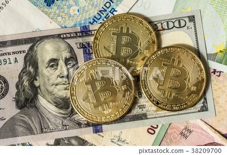 Golden bitcoin over multi currency banknotes  38209700