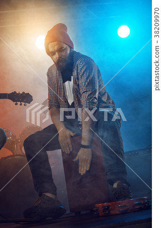 Rock band performs on stage. Guitarist, bass guitar and drums. Rock band performs on stage. Guitarist, bass guitar and drums. 38209970