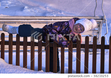 Girl child climbs the fence. Fun time is childhood Girl child climbs the fence. Fun time is childhood 38210253