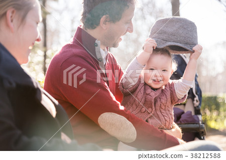 Young family with cheerful child in the park. Young family with cheerful child in the park. 38212588