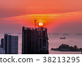 Construction crane and skyscraper in the sunset. 38213295