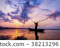 Asian fisherman on wooden boat casting a net for c 38213296