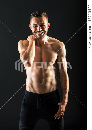 Smiling muscular shirtless man Smiling muscular shirtless man 38213465