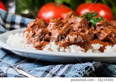 Chicken tikka masala served with rice 38214360