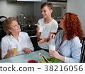 Happy granny drinking juice with children in the 38216056