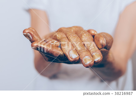 Golden female hands on a white background 38216987