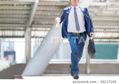 Businessman is rushing to work on time. 38217109
