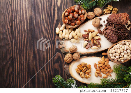 Various nuts on wooden table 38217727