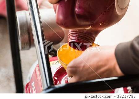 Farmer fill fuel into self-priming water pump Farmer fill fuel into self-priming water pump 38217785