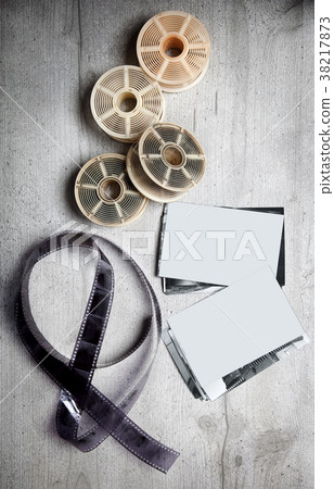 Old photoghraphic film on wood background  38217873