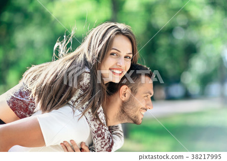 Outdoors portrait of lovers happy young man and woman 38217995