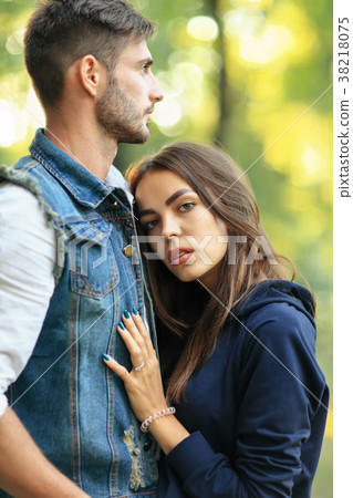 Young beautiful woman embracing her man outdoors 38218075
