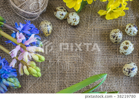 spring flowers, quail eggs on burlap background 38219780