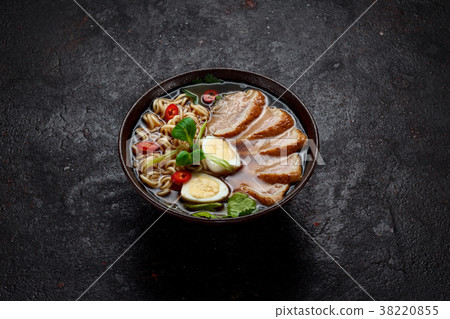 Ramen soup over dark background. 38220855